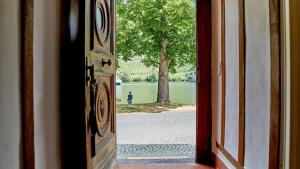 an open door with a view of a park with a tree at NEU!!! Moselbleibe Uferallee in Bernkastel-Kues