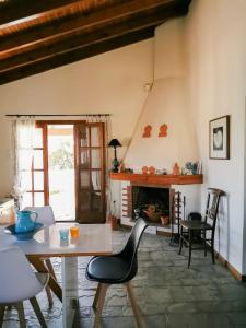 a living room with a table and a fireplace at Villa Christina in Karfas