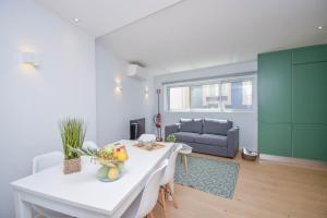 a living room with a white table and a couch at Central & Stylish 2 Bedroom Apartment w/ Balcony in Cascais