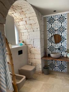a bathroom with a toilet and a sink at Donna Silvia Apartments in Castellana Grotte