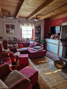 a living room with a couch and a fireplace at Domek letniskowy Wczasy nad morzem in Sasino