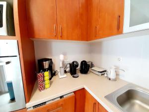 a kitchen counter with a coffee maker and appliances on it at Beautiful house with great castle view! in Myrina