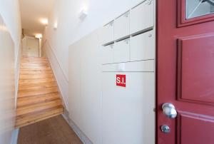 a red door in a hallway with a staircase at Tripas Coração Taipas Historical Center in Porto