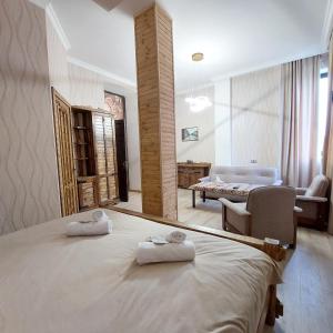 a bedroom with a large bed with towels on it at Via Gyumri in Gyumri