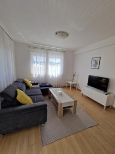 a living room with a couch and a coffee table at Apartment Melody in Metković