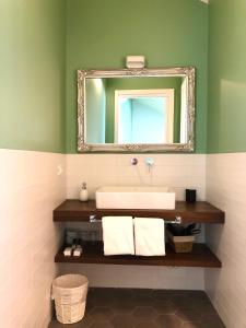 a bathroom with a sink and a mirror at Antica Locanda Leonardo in Milan