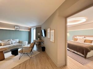 ein Hotelzimmer mit einem Bett und einer Couch in der Unterkunft Emeria Dinard Thalasso Spa in Dinard