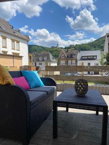 a patio with a couch and a table with a view at NEU!!! Moselbleibe Winzerhaus Kues in Bernkastel-Kues