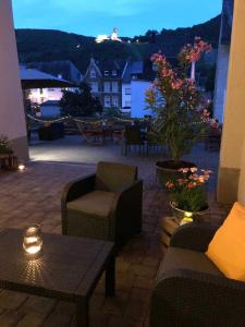 a patio with chairs and a table with a view at NEU!!! Moselbleibe Winzerhaus Kues in Bernkastel-Kues