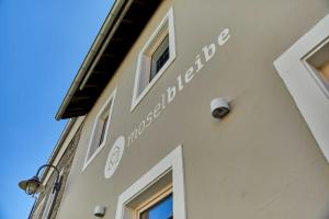a building with a sign on the side of it at NEU!!! Moselbleibe Winzerhaus Kues in Bernkastel-Kues +57 photos