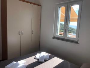 a bedroom with a bed and a window at Apartmani Ivana in Cres +38 photos