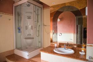 a bathroom with a shower and a sink at Guesthouse "Villa Tamas" in Limone sul Garda