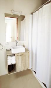 a bathroom with a sink and a mirror at Apart Las Tunas Carmelo in Carmelo