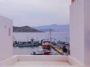 a view of a harbor with boats in the water at Under the Castle - In the heart of the Old Town in Naxos Chora
