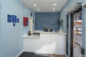 a kitchen with a white counter and blue walls at Hotel Aria in Mountain View