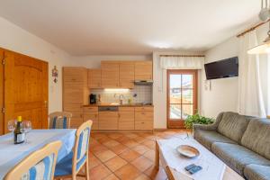 a living room with a table and a couch at Haus Bellutti in Termeno