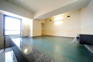 a gymnasium with a pool of water in a room at HOTEL BB fast Yonezawa in Yonezawa