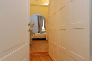 a door leading into a room with a bedroom at Madonna de' Monti Suites in Rome