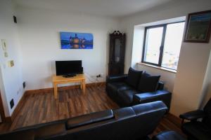 a living room with a couch and a table at Seaside Views in Galway