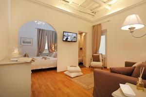 a large living room with a bed and a couch at Madonna de' Monti Suites in Rome