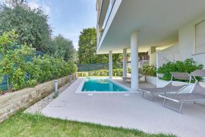 a swimming pool in the backyard of a house at ApartmentsGarda - Le Terrazze Del Garda Residence in Lazise