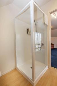 a large glass closet in a room with a table at Garden City Motel in Christchurch