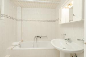 a white bathroom with a sink and a bath tub at Premier Tsilivi in Tsilivi