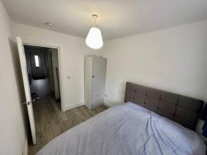 a bedroom with a large bed in a room at 2 Bedroom house,BrownhillRd SE6 in London