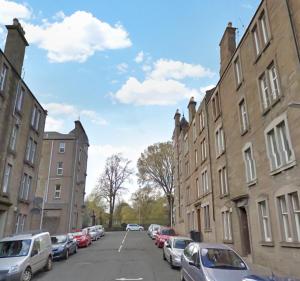 a city street with parked cars and buildings at Baxter Park - City Base in Dundee