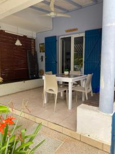 a white table and chairs on a patio at La Case de Guy in Le Gosier