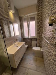 a bathroom with a sink and a toilet at Hotel Europa Parking in Livorno