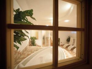 a view of a bath tub through a window at HOTEL BOSCO VERDE in Val di Zoldo