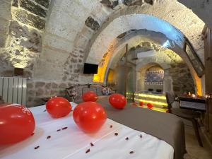 a table with red balloons on top of a table in a castle at Zuwinasa House Hotel in Avanos