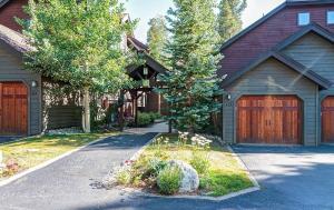a house with two garage doors and a driveway at Luxury Modern Townhome steps to ski lifts and downtown with Nature at your patio in Breckenridge