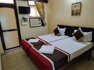 a bedroom with a bed with two towels on it at Sea View Resorts in Bogmolo