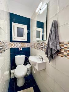 a bathroom with a white toilet and a sink at Zoe's House Skiathos. Centre of Skiathos in Skiathos