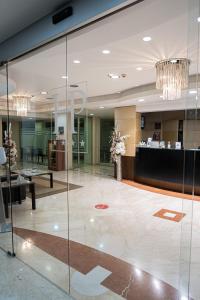 a lobby with glass walls and a reception desk at Hotel Premiere in Marina di Varcaturo