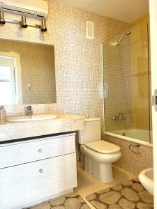 a bathroom with a toilet and a sink and a shower at Bahía del Sol 17C Peñon & Sea View Arenal Beach in Calpe