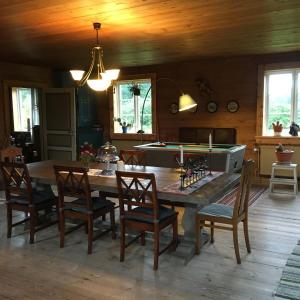 a dining room with a table with a pool table at La Maison Rouge de Slätten Bed and Breakfast in Vilshult