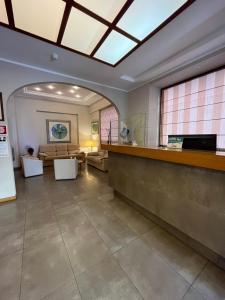 a large lobby with a waiting area with a reception counter at Hotel Europa Parking in Livorno