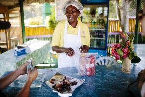 a woman standing in front of a table with food at Galina Breeze in Port Maria