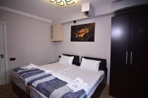a small bedroom with a bed with two towels on it at La Casa Hotel Yerevan in Yerevan