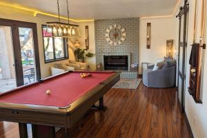 a living room with a pool table in it at The Arrowhead Oasis - hot tub, heated pool, fire pits, backyard games in Glendale