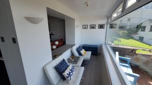 a living room with two couches and a window at A View With A Room in Penrhyn Bay