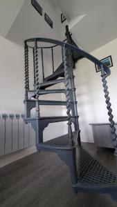 a metal spiral staircase in a room at A View With A Room in Penrhyn Bay