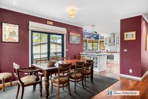 a kitchen and dining room with a wooden table and chairs at 29 Church Street, Cowes in Cowes