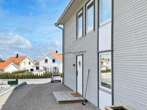a house with a car parked outside of it at Holiday home Vesterøy II in Rød