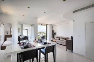 a kitchen and living room with a table and chairs at Sea View Heaven by Five Stay in Herzliya B