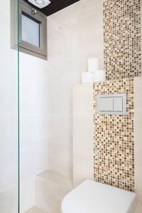 a bathroom with a toilet and a glass shower at Sea View Heaven by Five Stay in Herzliya B