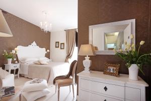 a bedroom with a bed and a mirror at Daplace - HQH Colosseo in Rome